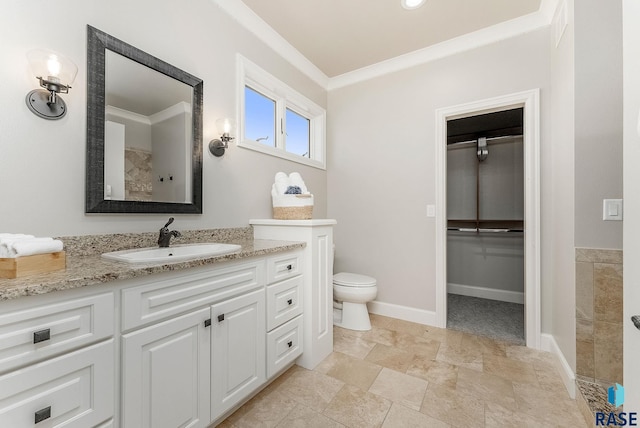 bathroom with baseboards, ornamental molding, toilet, and vanity