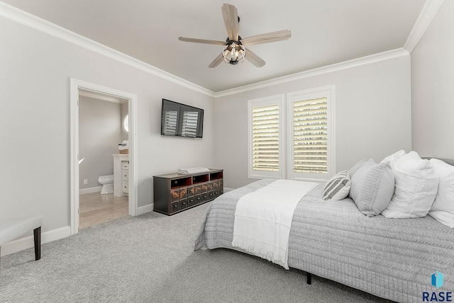 bedroom with crown molding, baseboards, ceiling fan, ensuite bath, and carpet floors