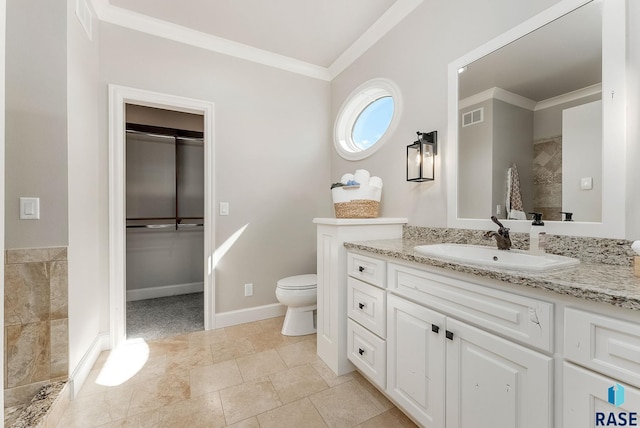 bathroom featuring toilet, vanity, crown molding, and visible vents