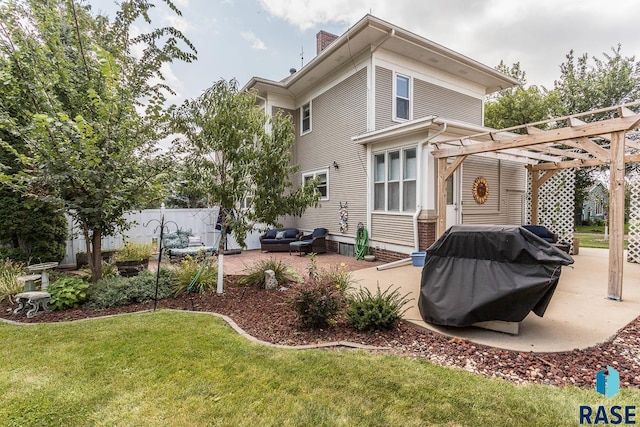 1220 NE 3rd St, Madison, SD 57042 - rear view of property with a lawn, a pergola, fence, and a patio area