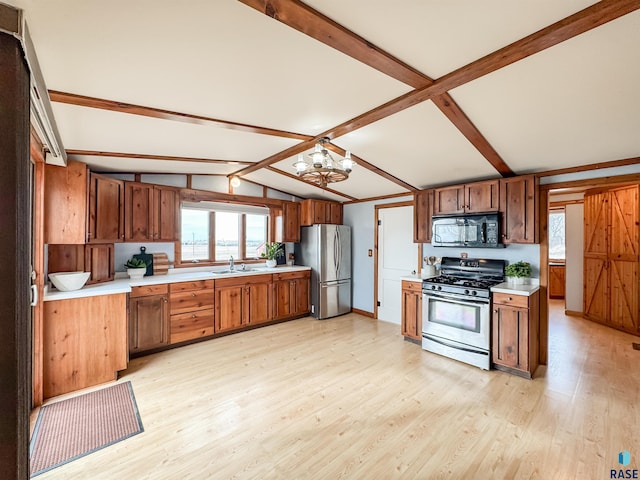 kitchen with light countertops, light wood-style flooring, and appliances with stainless steel finishes