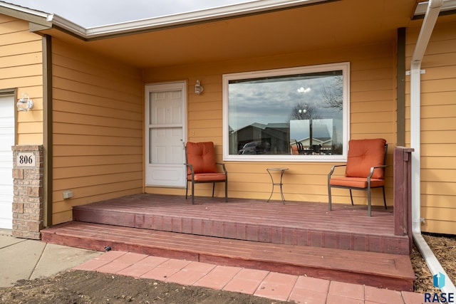 view of exterior entry featuring covered porch