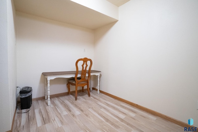 home office featuring baseboards and light wood finished floors