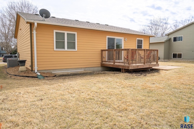 back of house with central AC, a yard, and a wooden deck