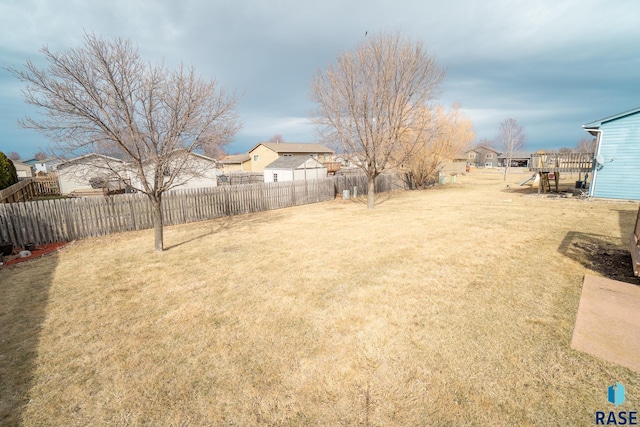 view of yard featuring a fenced backyard and a residential view