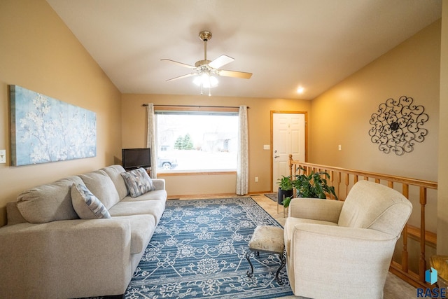 living room with baseboards, vaulted ceiling, and a ceiling fan
