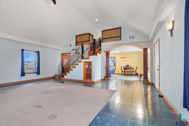 29783 Frog Creek Rd, Centerville, SD 57014 - tiled entrance foyer featuring high vaulted ceiling, visible vents, baseboards, decorative columns, and arched walkways