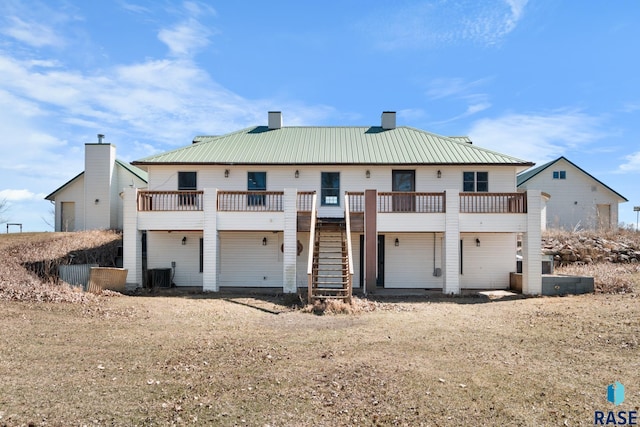 29783 Frog Creek Rd, Centerville, SD 57014 - view of front of home with stairway, a chimney, a wooden deck, metal roof, and central AC