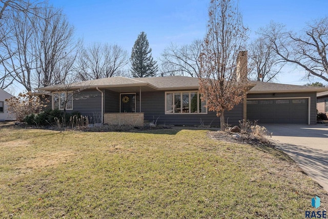 single story home with a chimney, a front yard, driveway, and an attached garage