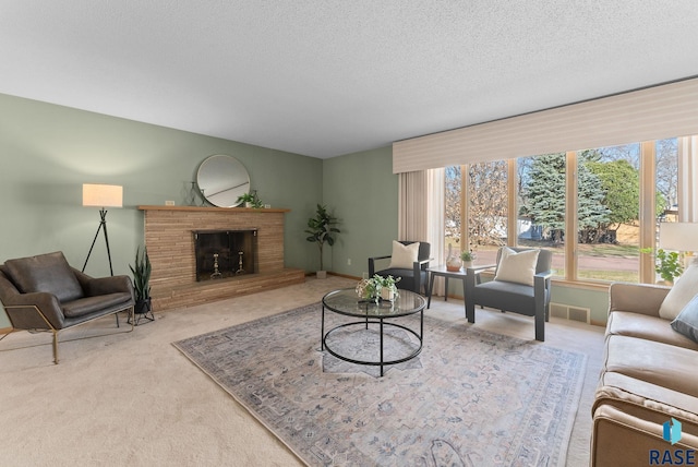 carpeted living room featuring a brick fireplace, visible vents, and a textured ceiling
