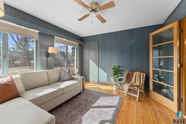 living area with hardwood / wood-style floors and a ceiling fan
