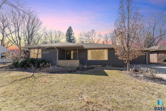 view of front of house with a front lawn, a garage, and concrete driveway