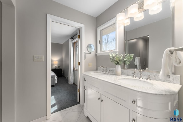 full bathroom featuring connected bathroom, double vanity, and a sink