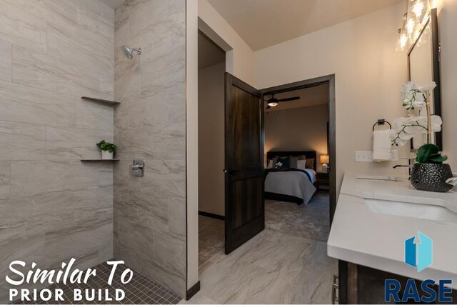 ensuite bathroom featuring connected bathroom, tiled shower, a sink, marble finish floor, and double vanity