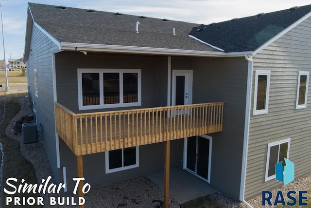 back of property with a patio, a shingled roof, and central AC unit