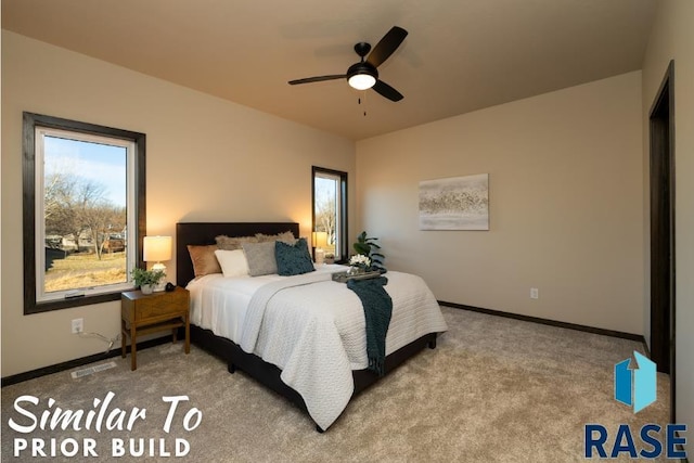 carpeted bedroom with baseboards, visible vents, and a ceiling fan