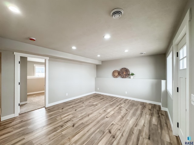 below grade area with baseboards, visible vents, wood finished floors, and recessed lighting