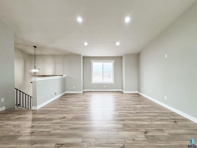 spare room featuring baseboards, recessed lighting, and light wood finished floors