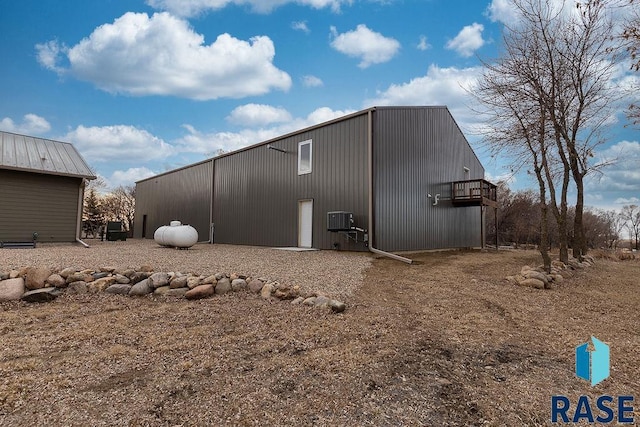 view of side of property featuring an outbuilding, central AC, and an outdoor structure