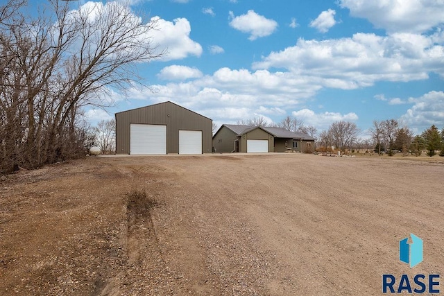 exterior space with a detached garage and an outdoor structure