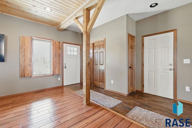 foyer with visible vents, wood finished floors, recessed lighting, beam ceiling, and wooden ceiling