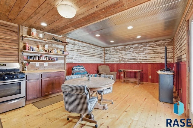 interior space with a wainscoted wall, wood walls, light wood finished floors, recessed lighting, and wooden ceiling