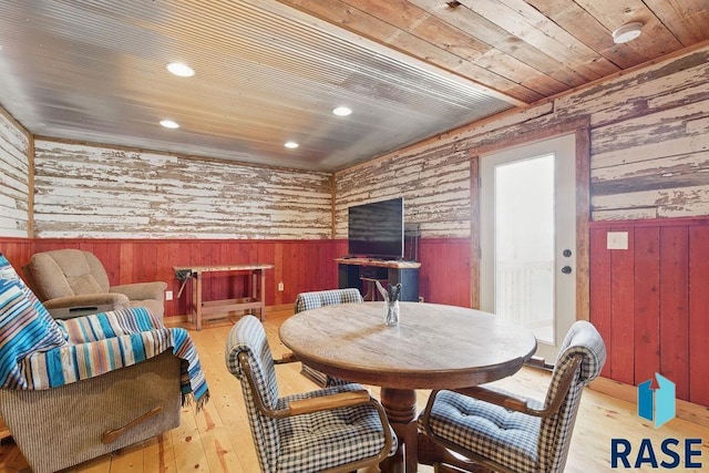 dining room with wooden walls, hardwood / wood-style flooring, wainscoting, recessed lighting, and wooden ceiling