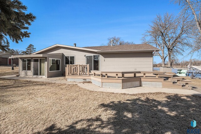 rear view of house with a deck and a patio