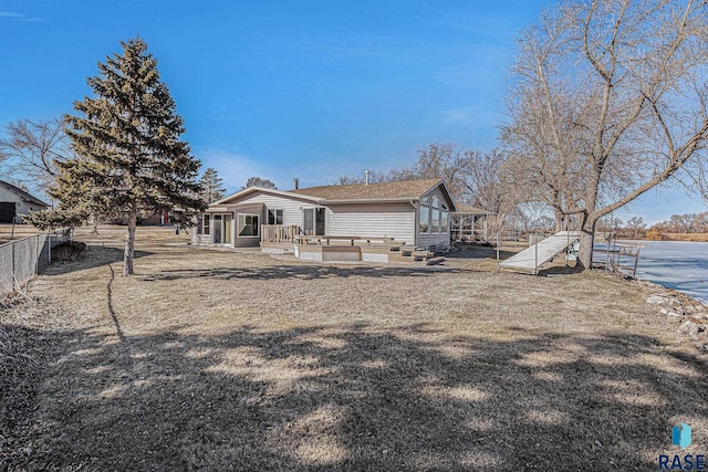 rear view of house featuring fence