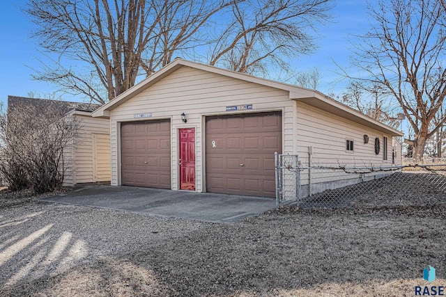 detached garage featuring fence