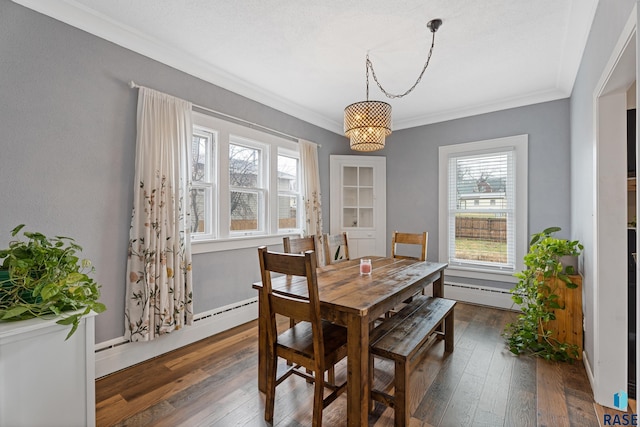 dining area with baseboard heating, dark wood-style floors, a chandelier, and crown molding