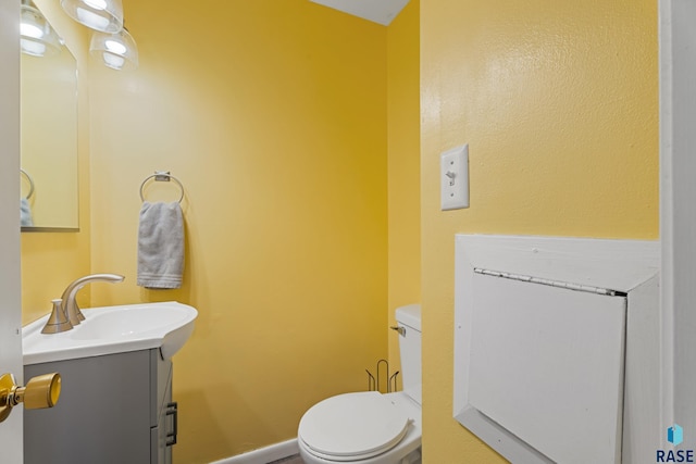 bathroom with toilet and vanity