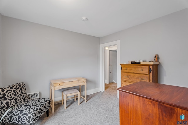 living area featuring light carpet and baseboards
