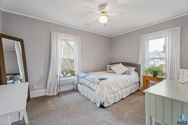 carpeted bedroom featuring a textured wall, ornamental molding, multiple windows, and ceiling fan