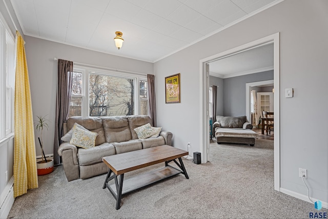 living room with crown molding, baseboards, and light colored carpet