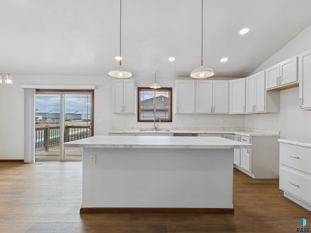 kitchen with a wealth of natural light, dark wood-style flooring, a sink, and a kitchen island