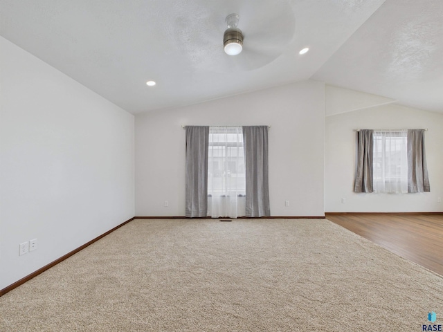 unfurnished room featuring baseboards, vaulted ceiling, and a ceiling fan