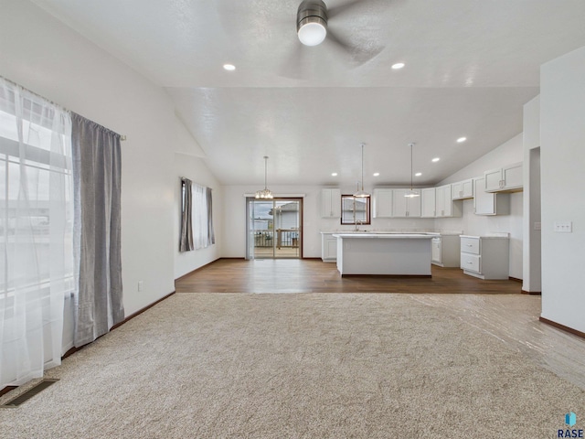 unfurnished living room featuring lofted ceiling, ceiling fan, visible vents, and recessed lighting