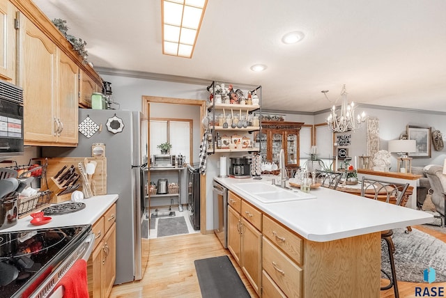 kitchen with a sink, a peninsula, light wood-type flooring, stainless steel appliances, and ornamental molding