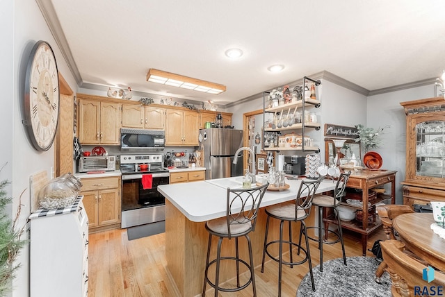 kitchen with light countertops, a peninsula, light wood-style flooring, stainless steel appliances, and ornamental molding