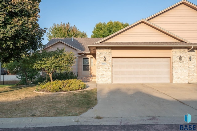 4612 E Pampas Pl, Sioux Falls, SD 57110 - ranch-style home featuring a front yard, an attached garage, concrete driveway, brick siding, and roof with shingles