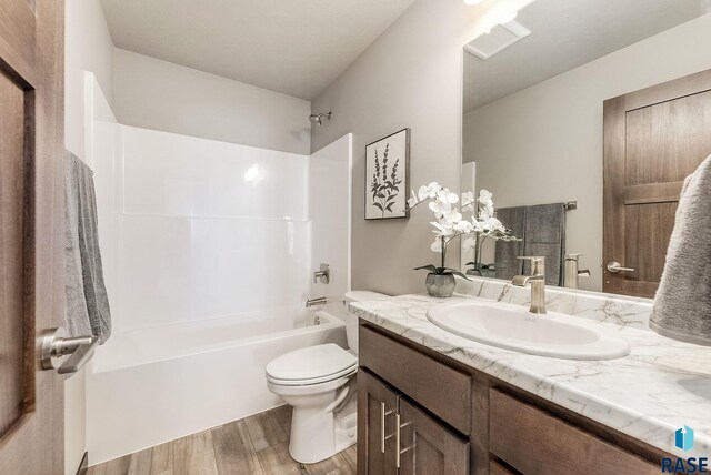 1320 Poplar Ave, Tea, SD 57064 - full bathroom featuring toilet, wood finished floors, vanity, and shower / tub combination