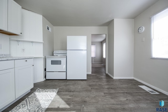 kitchen with dark wood finished floors, white cabinetry, white appliances, and visible vents