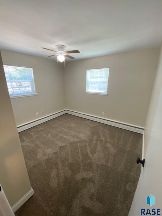 3016 E 20th St, Sioux Falls, SD 57103 - carpeted empty room featuring a baseboard heating unit, plenty of natural light, baseboards, and a ceiling fan