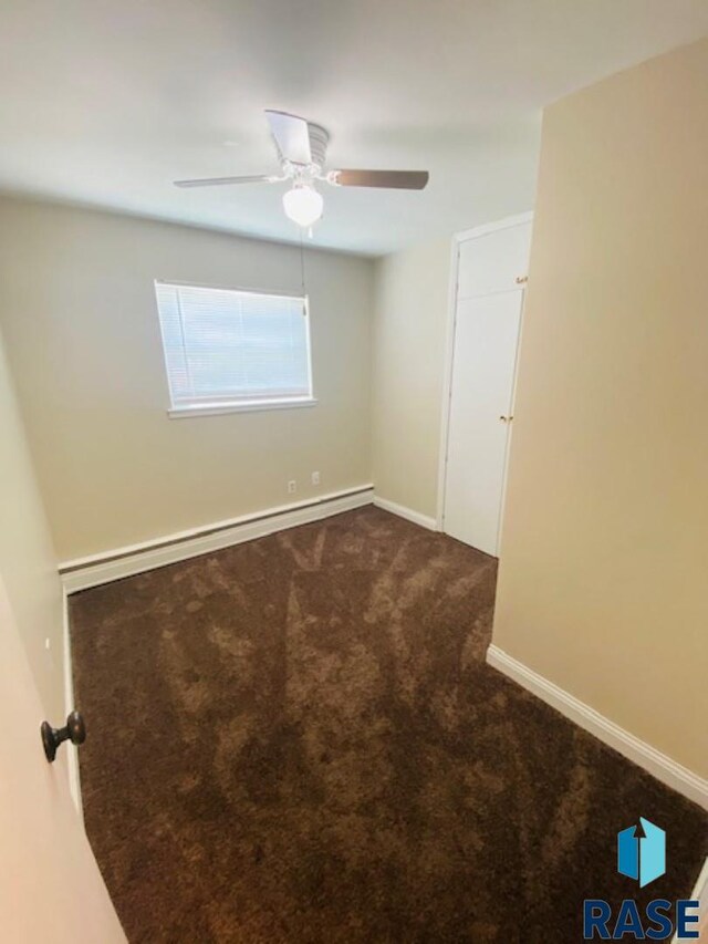 3016 E 20th St, Sioux Falls, SD 57103 - empty room featuring ceiling fan, dark colored carpet, and baseboards