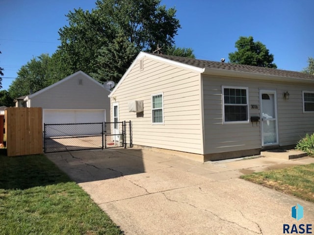 3016 E 20th St, Sioux Falls, SD 57103 - view of property exterior with a detached garage, fence, an outdoor structure, and a gate