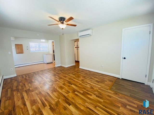 3016 E 20th St, Sioux Falls, SD 57103 - unfurnished room with baseboards, an AC wall unit, a baseboard radiator, a ceiling fan, and wood finished floors