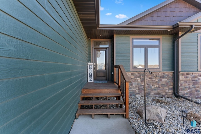 view of exterior entry featuring stone siding