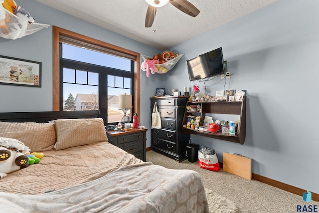 bedroom with a textured ceiling, ceiling fan, baseboards, and carpet floors