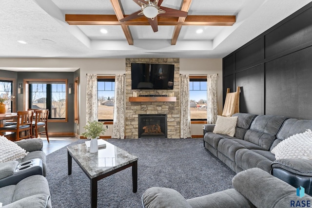 living room featuring a wealth of natural light, a ceiling fan, beam ceiling, and coffered ceiling